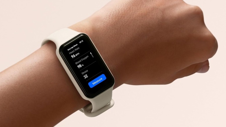 Amazfit Band 7 fitness tracker on a wrist with AMOLED display on.