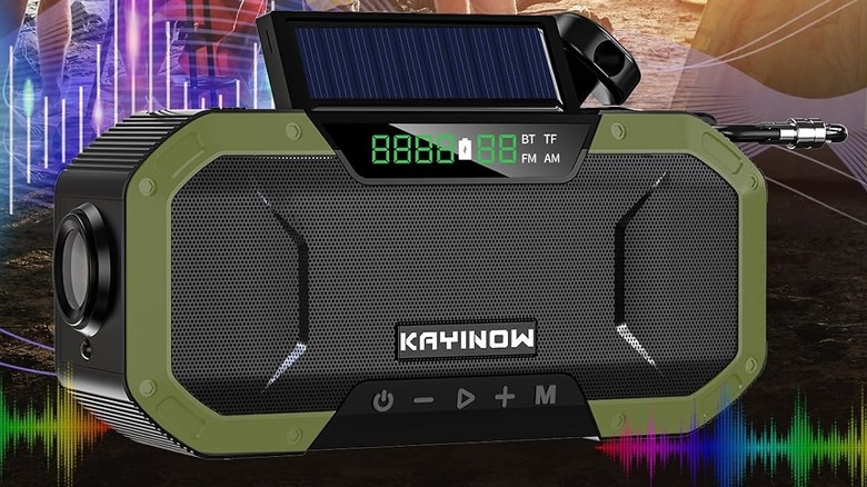 Close up of a rugged looking radio with a solar panel on top