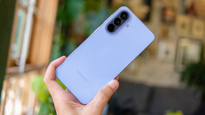 The Samsung Galaxy A57 5G in Awesome Lilac color, held in hand