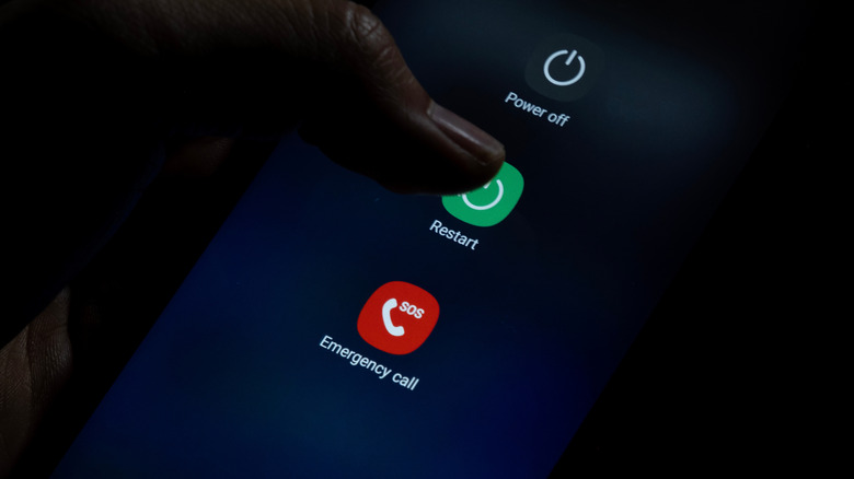 A person pressing Restart in the Power settings