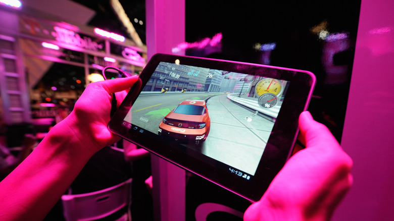 person gaming on a tablet