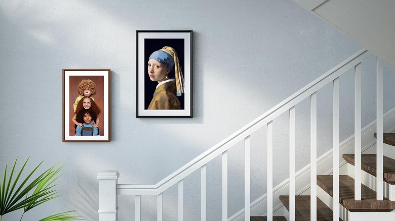 Netgear Meural Canvas II digital art frame on a wall in a home.