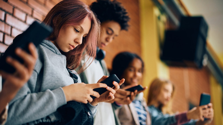 A group of young people all using phones