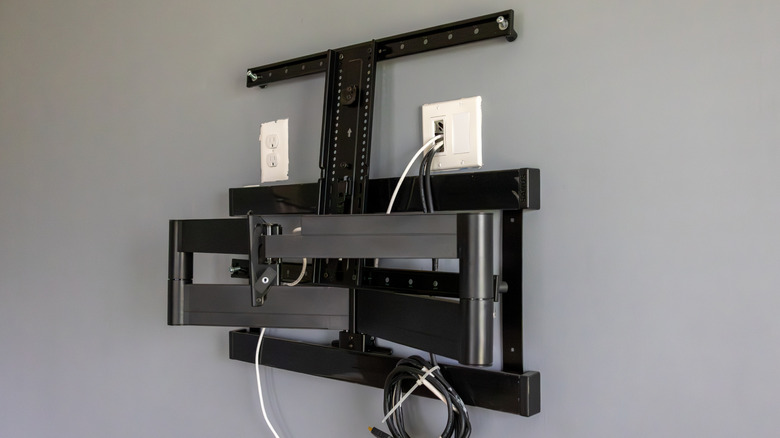 A full-motion TV wall mount fixed to a wall.