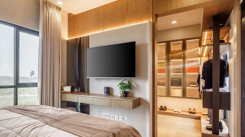 A wall-mounted TV in a modern bedroom.