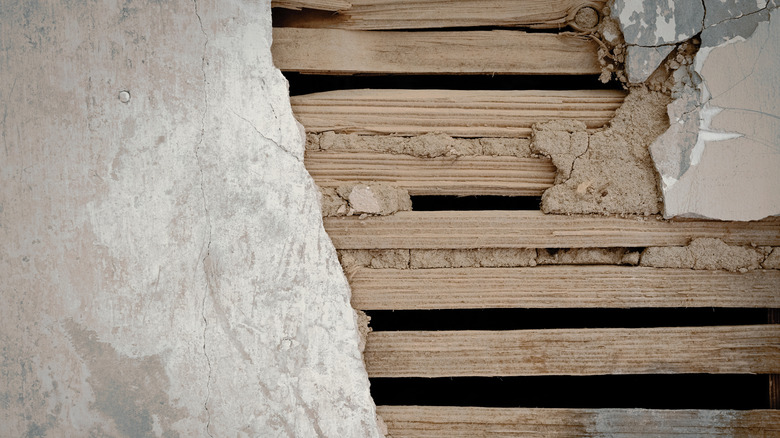 A lath and plaster wall with its lath layer exposed.
