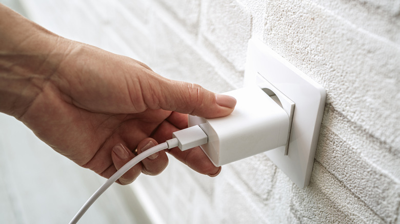 Plugging an a charger into an outlet