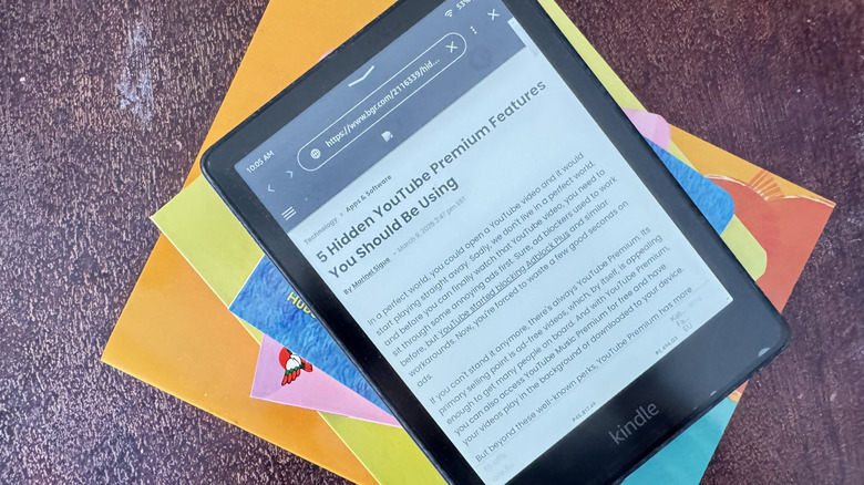 Kindle on top of books showing web browser