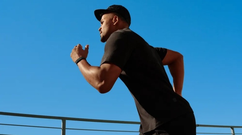 Man running while wearing Google Fitbit Air band