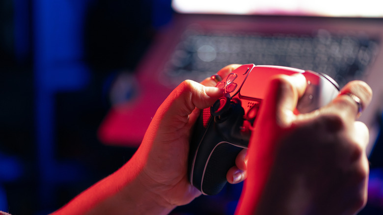 A picture of someone holding a PS5 controller