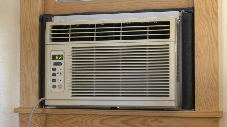 A small AC unit mounted inside a window