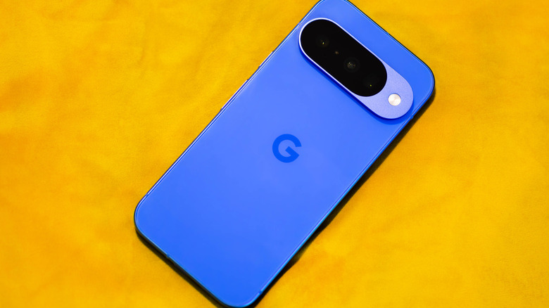 a blue Google Pixel 10 on a yellow background.