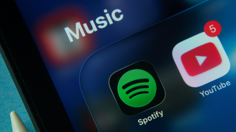 close-up of smaratphone music folder with spotify and youtube icons showing