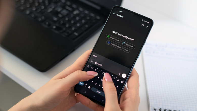 A woman typing on a smartphone in the ChatGPT app.