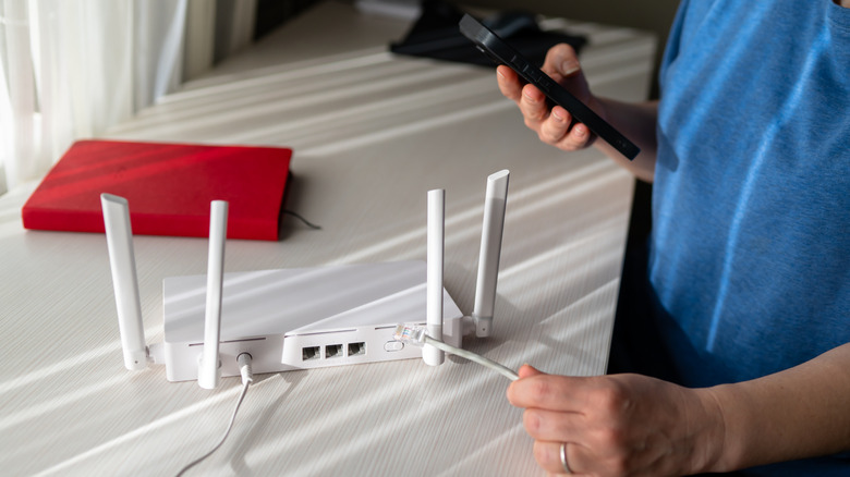 A person examining wi-fi router specs on a smartphone