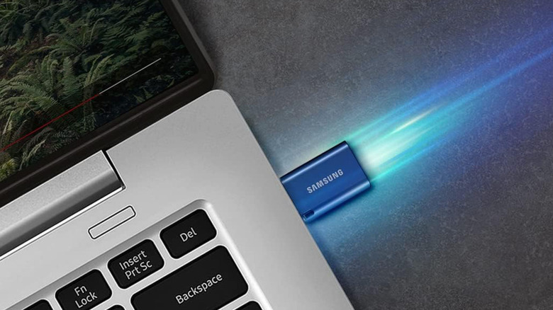 A blue Samsung USB-C flash drive connected to a laptop