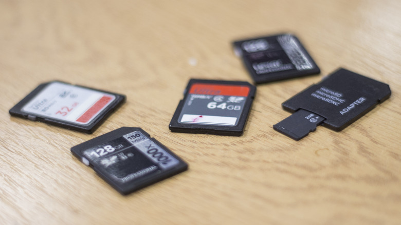 Small collection of SD cards and a Micro SD card with an adapter on a desk.