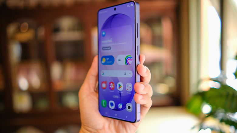 A hand holding up a Samsung Galaxy phone