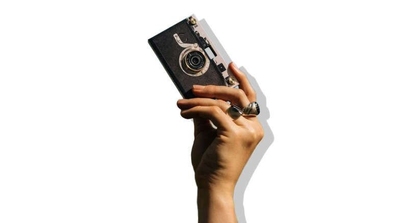 Holding the Paper Shoot Camera against a white background