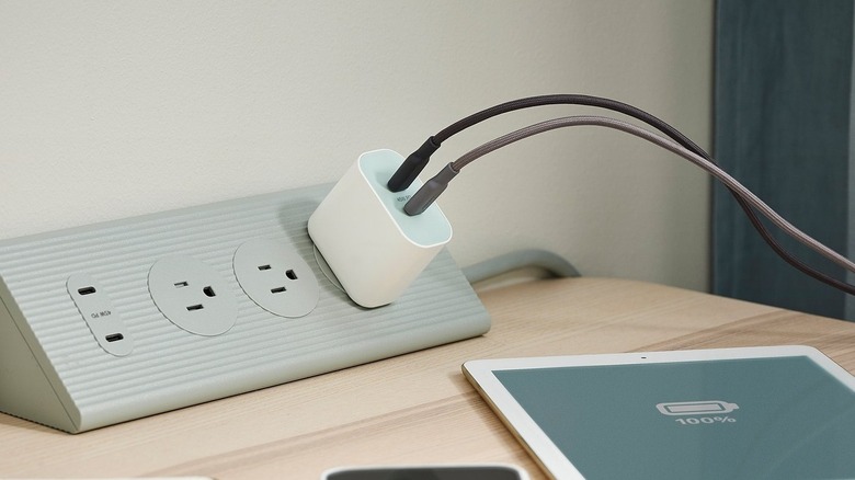 A Sjöss 45W 2-port USB-C Charger connected to a power strip and charging two devices
