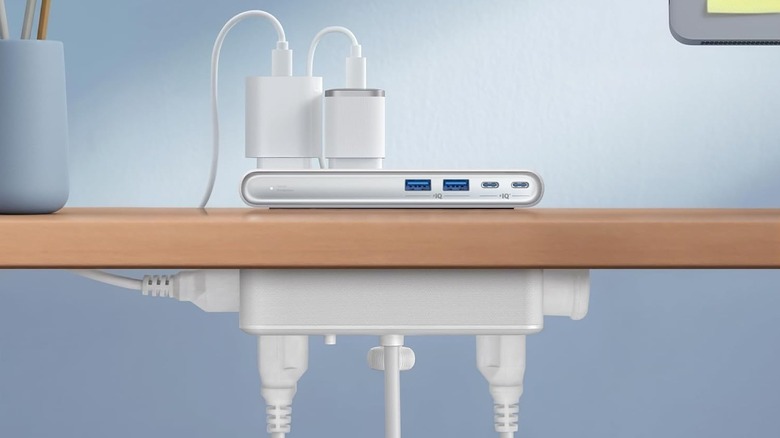 Anker Nano Power Strip with Clamp mounted to a table's top with multiple devices connected