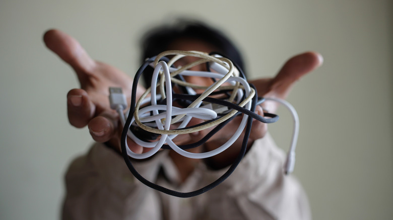 Close-up of a tangled bundle of electronic cables highlighted in front of the camera