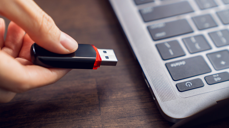 Handing inserting a flash drive into a laptop