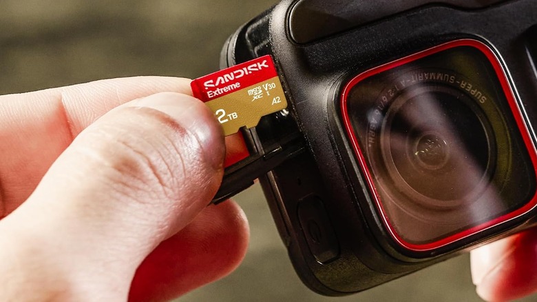 The SanDisk Extreme microSDXC Card being inserted in a camera