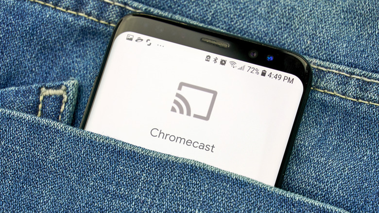 chromecast logo on a smartphone sticking out of a pocket on a pair of jeans