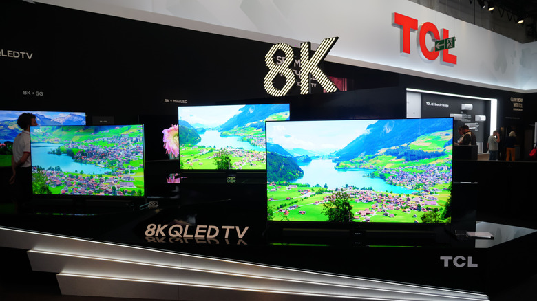 several TCL tvs in a line at an electronic expo