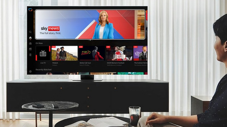 A person watching a Samsung Smart TV in a living room