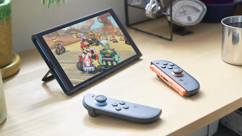 A Nintendo Switch 2 in tabletop mode playing Mario Kart World with the Joy Con detached on the table in front of it