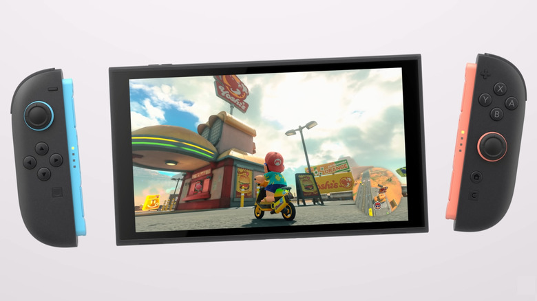 A Nintendo Switch 2 on a white background with Mario Kart World playing on the screen and detached Joy Con 2 on either side