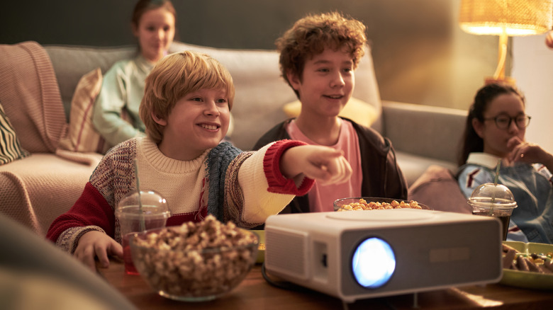 A family using a projector in an indoor setting.