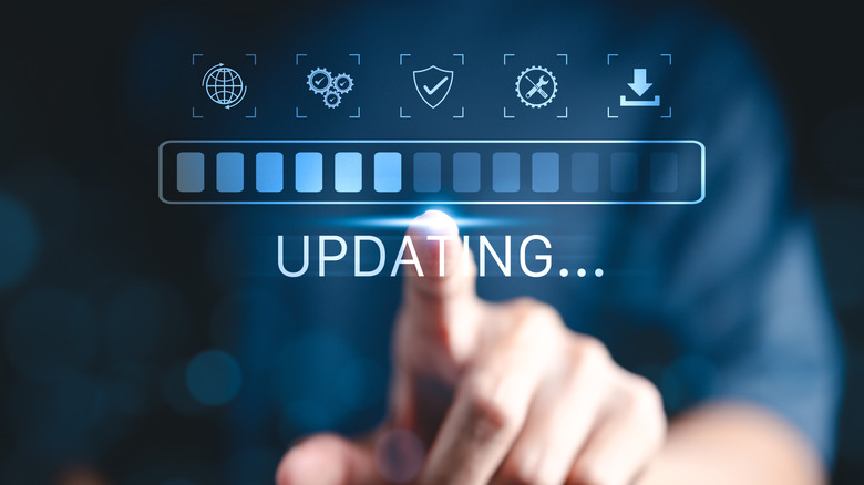 Close-up of man's finger with graphic indicating software updates taking place