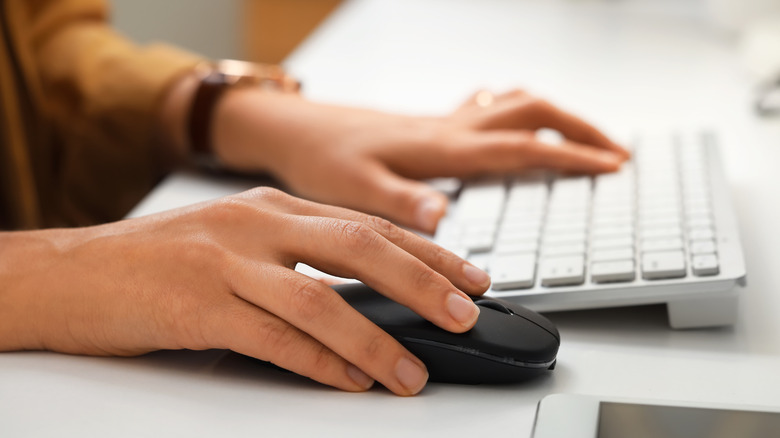 A person using a keyboard and mouse
