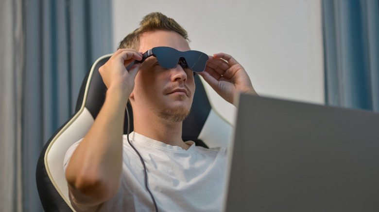 A man wearing AR/XR glasses