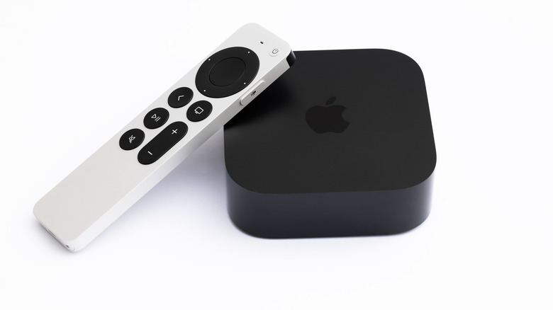 The 2022 Apple TV 4K with a white controller leaning on it.
