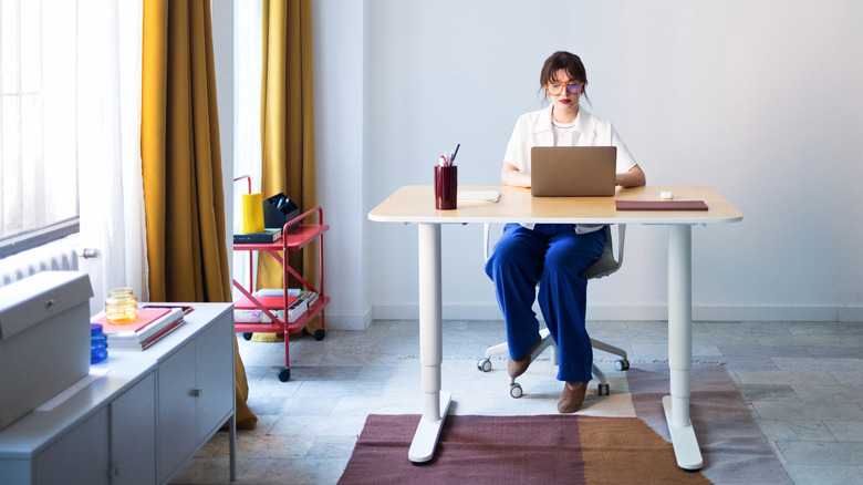 A woman sitting at her desk.