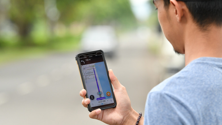 person using Waze app