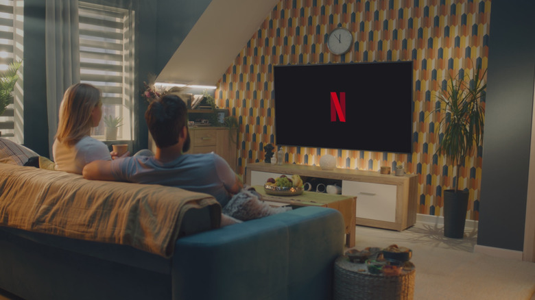 Couple watching Netflix on a living room TV