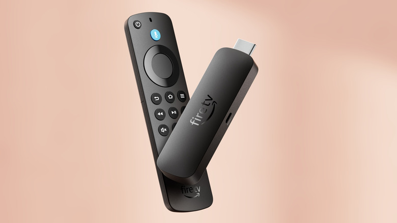 Amazon Fire TV Stick 4K Select on a pink-ish background.