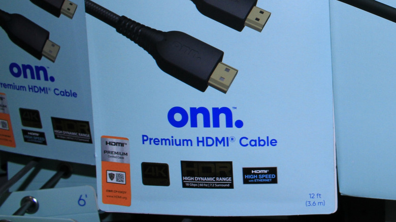 A closeup of HDMI cables in boxes at a Walmart store