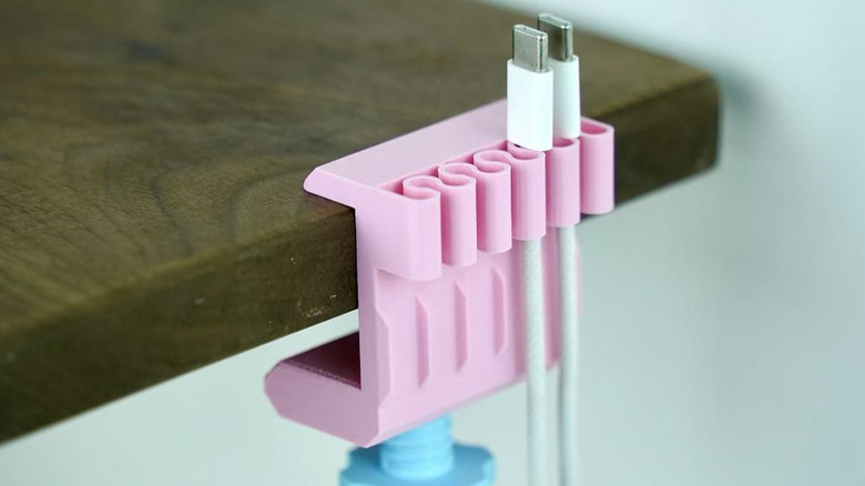 A 3D printed desk-clamping cable organizer.