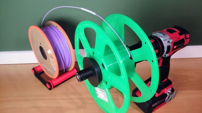 A 3D printer filament respooler mounted to a power drill.