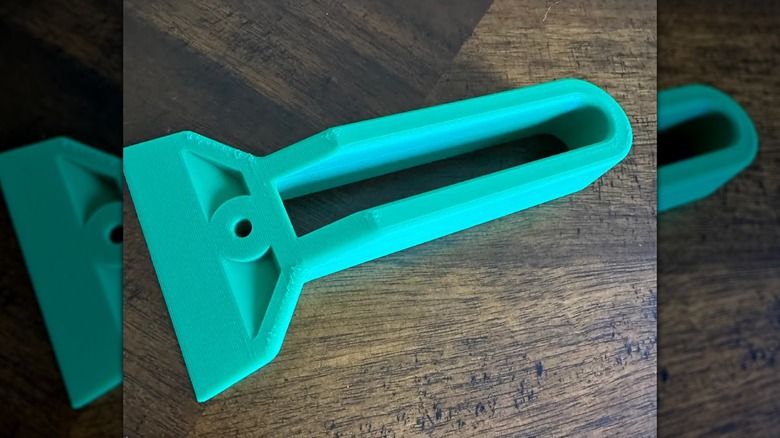 A 3D printed bed scraper tool.