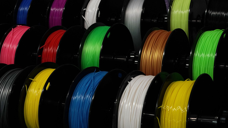 Multiple spools of 3D printer filament.
