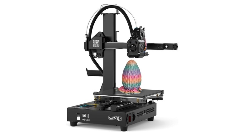 Tronxy Crux 1S printing a flexible dragon and egg in a rainbow filament.