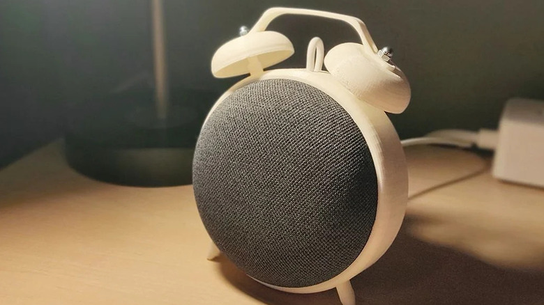 A google Nest Mini speaker in a 3D printed stand resembling a vintage alarm clock