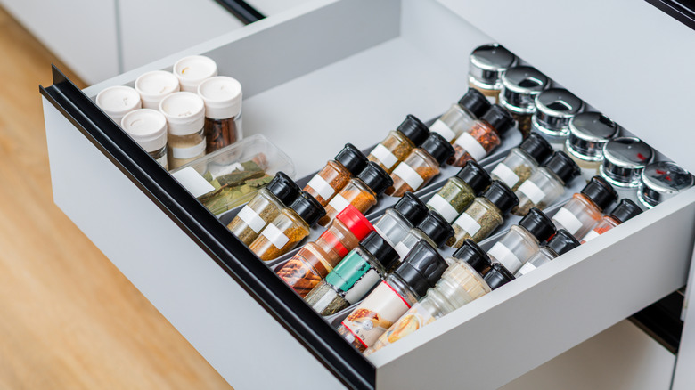Items in a drawer are arranged in plastic drawer organizers
